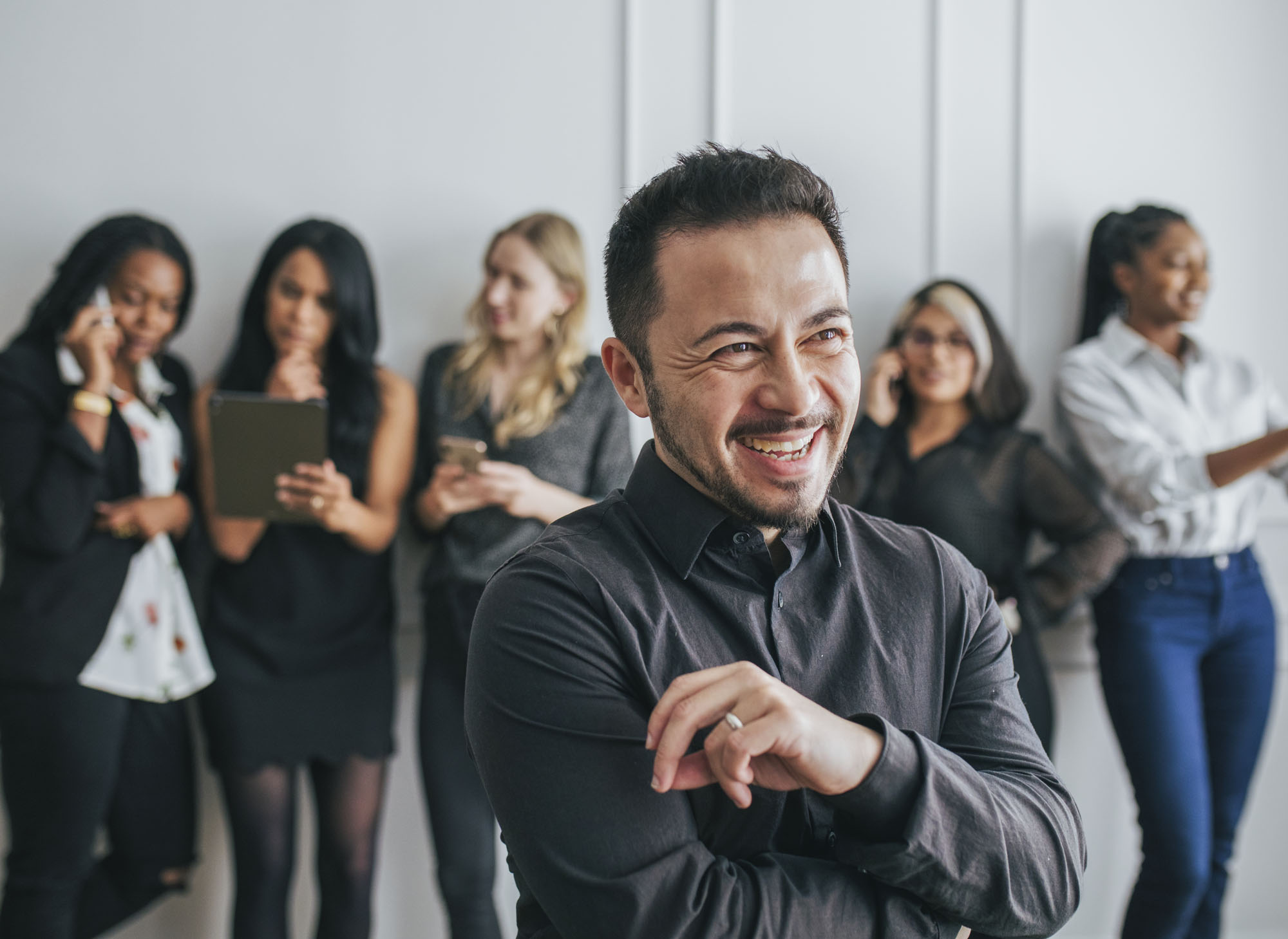 CEO with his employees standing by a white wall CEO with his employees standing by a white wall